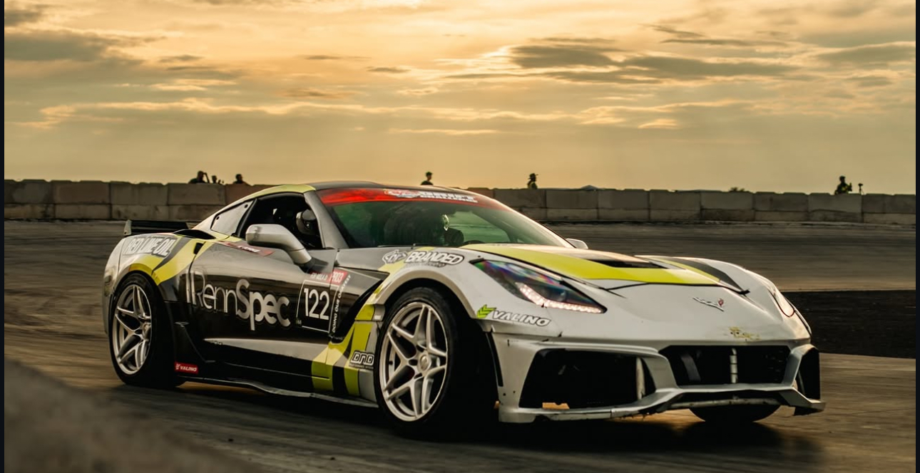 Rennspec-branded Corvette with black, silver and lime motorsports graphics on track