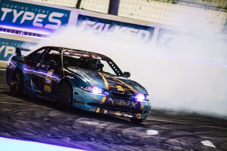 Black and blue Nissan drift car with a custom Rennspec motorsports wrap