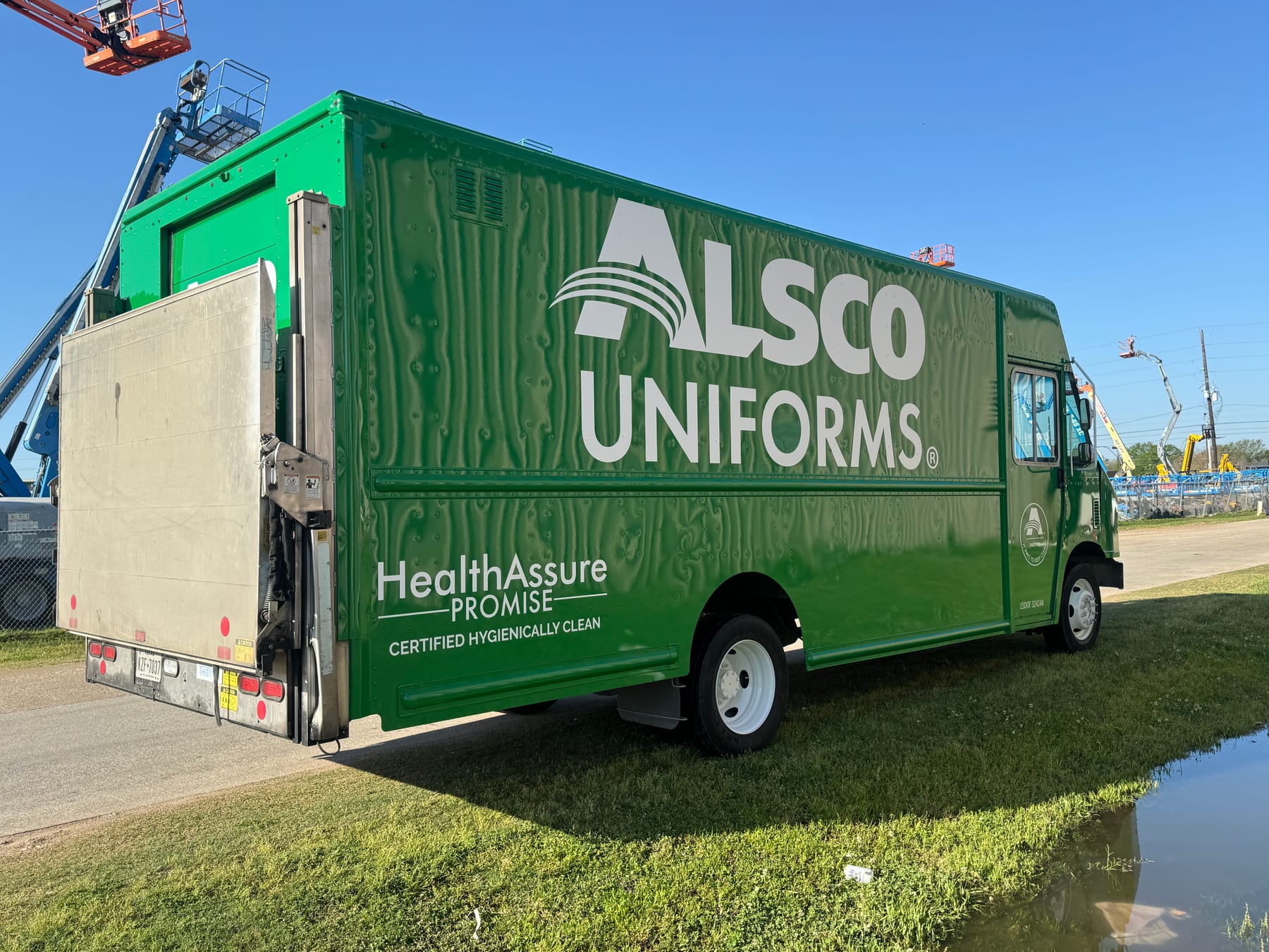 Green full box truck wrap for a uniform service company
